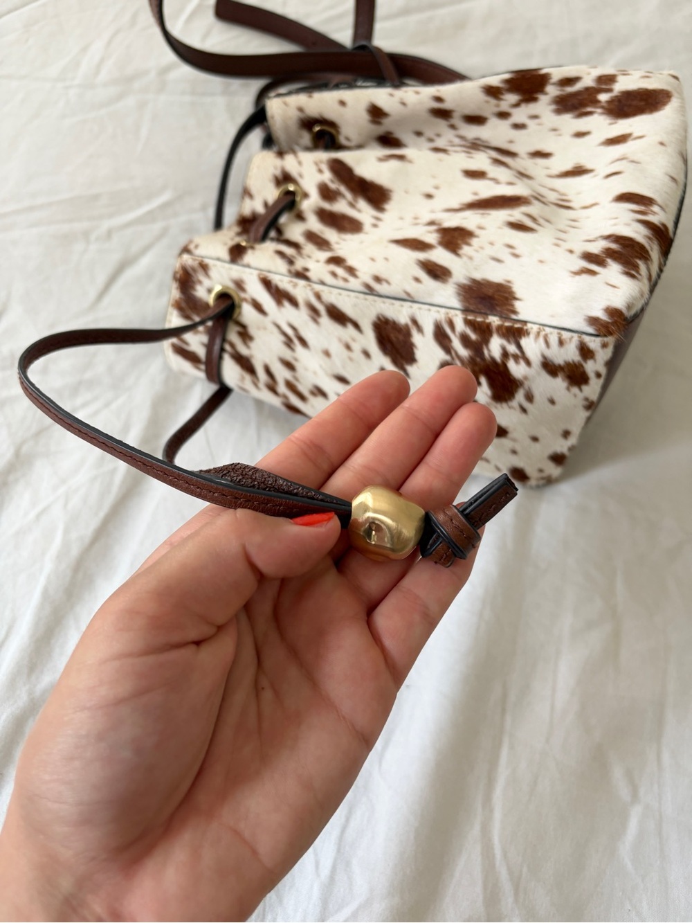 The Mini Drawstring Crossbody Bucket Bag Cow Print - Picture 7 of 11
